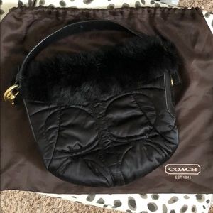 Black Coach bag trimmed in rabbit’s fur